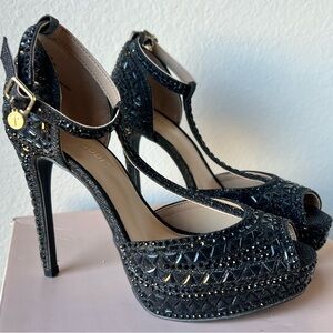 New in box , stunning bejeweled black heels size 7.